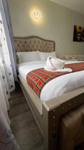 a bedroom with a bed with a blanket on it at Amber Home Ruaka Near Two Rivers Mall & UN in Ruaka