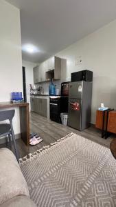 a kitchen with a stove and a refrigerator in it at Amber Home Ruaka Near Two Rivers Mall & UN in Ruaka