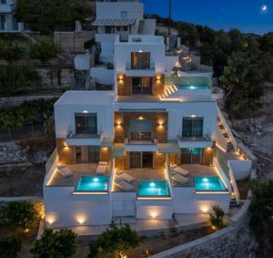 an aerial view of a white house at night at Myrthea Luxury Villas in Karpathos