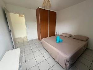 a bedroom with a bed with a blue toy on it at Lodge Tahiti in Papeete