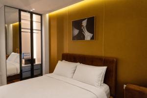 a bedroom with a bed and a mirror at Dream Luxury Suite in Tirana