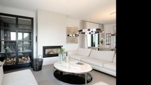 a living room with a white couch and a table at The One in Port d'Andratx