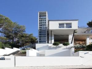 a white house with stairs in front of a building at The One in Port d'Andratx +16 photos