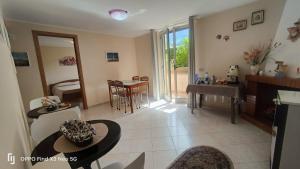 a living room with a table and a dining room at Villa Rosaria B&B in Morano Calabro
