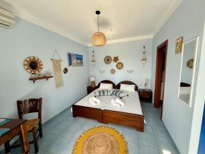 a bedroom with a bed and a table and chairs at Sun Thavma Living studio psiloritis in Lístaros
