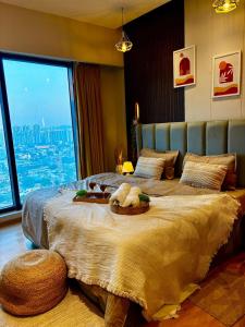 a bedroom with a large bed with a large window at Galaxy blue sapphire studio in Ghaziabad