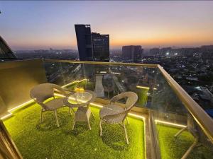 a table and chairs on top of a building at Galaxy blue sapphire studio in Ghaziabad