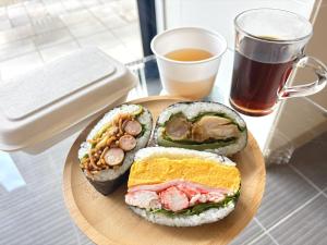 a plate of food with a sandwich and a cup of coffee at Green Rich Hotel Hiroshima Shinkansenguchi (Artificial hot spring Futamata Yunohana) in Hiroshima