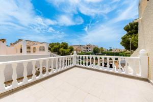 a balcony with white railings and a blue sky at Chalet Mayor Zenia Beach in Orihuela