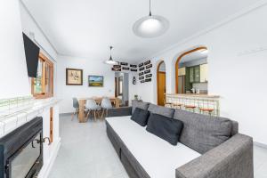 a living room with a couch and a fireplace at Chalet Mayor Zenia Beach in Orihuela