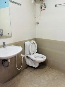 a bathroom with a toilet and a sink at SB Cottage ooty in Ooty