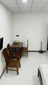 a dining room with a table and chairs in a room at Grand Stay Hotel in Seeduwa