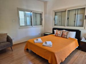 a bedroom with a bed with two towels on it at Villa Larnaca Bay Resort in Oroklini +48 photos