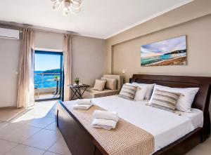 a bedroom with a large bed with a view of the ocean at Dina's Apartment in Himare