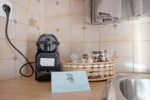 a tea kettle sitting on a counter next to a sink at Dionysus House in Magoulás +39 photos