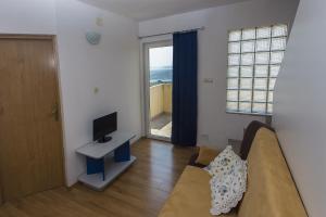 Televízia a/alebo spoločenská miestnosť v ubytovaní Gospodar Apartments