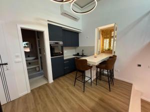 a kitchen with a table and chairs in a room at Peregrino Residence in Punat