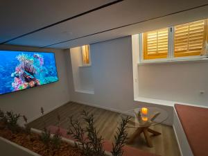 a living room with a flat screen tv on a wall at Peregrino Residence in Punat