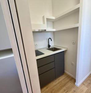 a small kitchen with a sink and a refrigerator at Peregrino Residence in Punat +11 photos