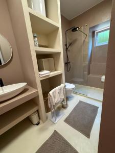 a bathroom with a shower and a sink and a toilet at Peregrino Residence in Punat