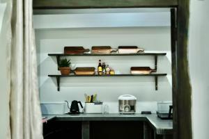 a room with a counter with shelves on the wall at Outdo'r Garden House in Tuy Hoa