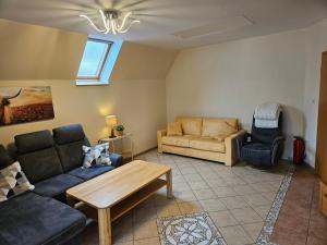 a living room with a couch and a table at Haus Seelter Gluk in Bollingen