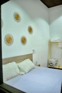a bedroom with a bed and three plates on the wall at Outdo'r Garden House in Tuy Hoa