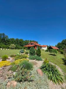 a garden in front of a house at D&A Vila - Private Villa with Sauna & Hot Tub in Arciūnai