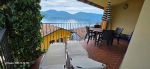 a balcony with a table and chairs with a view at Lakeview Residence in Oggebbio