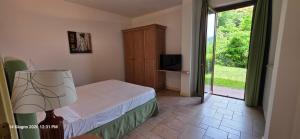 a bedroom with a bed and a sliding glass door at Lakeview Residence in Oggebbio +32 photos