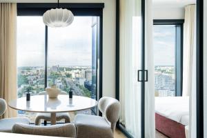 a room with a table and a bed and a window at J&K Towarowa Towers in Warsaw +41 photos
