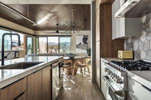 a kitchen with a sink and a stove top oven at Suncrest by Fieldtrip - JT Modern w Pool and Views in Joshua Tree