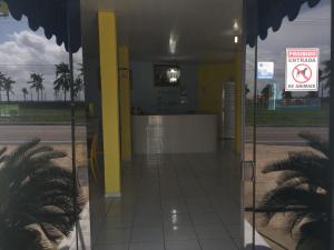 a gas station with a yellow pillar and a sign at Pousada Ilha do Sol in Salinópolis +62 photos