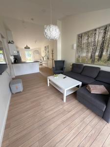 a living room with a couch and a coffee table at Bøtø strand ferielejlighed 3 in Bøtø By +8 photos