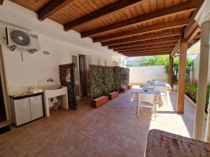 an outdoor patio with a table and chairs at B&B Mare di Ricordi Camera in San Foca