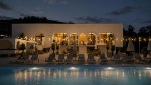a resort with a swimming pool at night at Moon Valley Comarnic in Sinaia