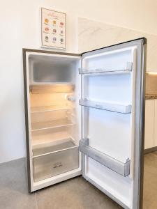 an empty refrigerator with its door open in a kitchen at Casa Le Dream (03) in Kuah
