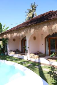 a villa with a swimming pool and a resort at La Calma Villa in Gili Islands