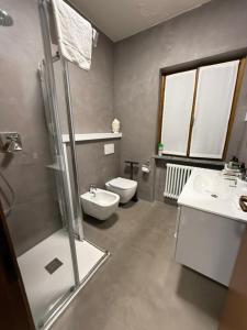 a bathroom with a shower and a toilet and a sink at Appartamento Vista Forra in Tremosine Sul Garda +10 photos