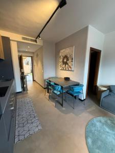 a living room with a table and blue chairs at Appartamento Vista Forra in Tremosine Sul Garda