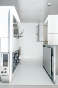a kitchen with white appliances and a refrigerator at Oyado Shinmachi Gojo in Kyoto +48 photos