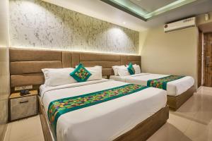 a hotel room with two beds in a room at Treebo Amber International Mumbai Airport T2 in Mumbai