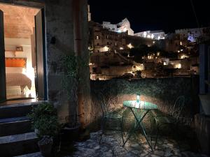 a table in a room with a view of a city at night at Da Ida - Matera Cento Storico - Sassi in Matera +24 photos