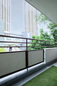 a balcony of a building with a view of tall buildings at NIYS apartments 37type in Tokyo