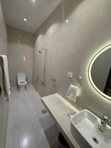 a bathroom with a sink and a toilet and a mirror at Hotel One Ten Mall Road Murree in Murree