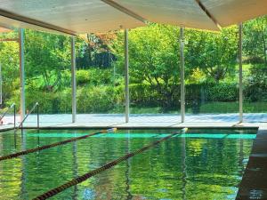 a swimming pool with a rope in the water at Hyatt Regency Beijing Wangjing in Beijing