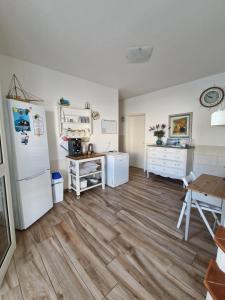a kitchen with a white refrigerator and a table at B&B Mare di Ricordi Camera in San Foca +19 photos