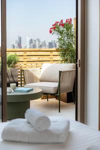 a room with a balcony with a table and a chair at Appart Hôtel Résidence Courcelle in Levallois-Perret