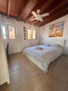a bedroom with a bed and a ceiling fan at Puerto Nest Hostel in Puerto de la Cruz