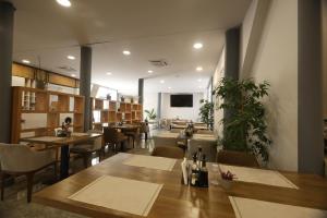 a restaurant with tables and chairs and a dining room at Metro Hotel Terminal in Tirana